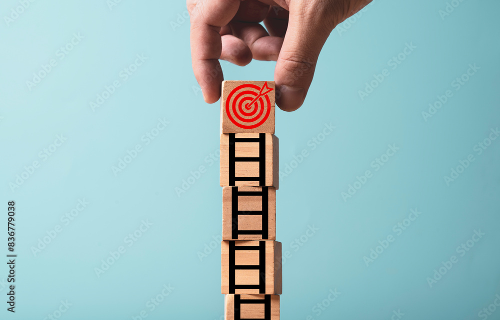 Poster hand put dartboard with arrow on the top of ladder for enhance and achievement setup business object