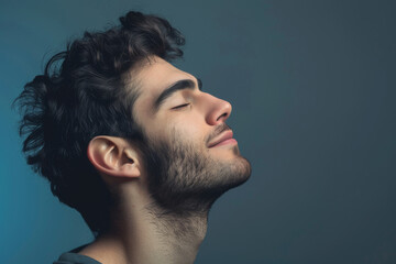 Fototapeta premium A close up of a man with beard and closed eyes looking to a side