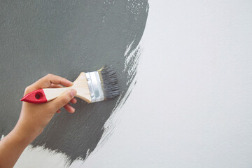 Brush Painting, Worker painting on surface wall  Painting apartment, renovating with grey color ...