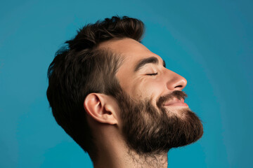 Fototapeta premium A close up of a man with beard and closed eyes looking to a side