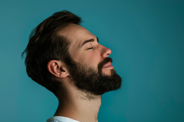 Fototapeta premium A close up of a man with beard and closed eyes looking to a side