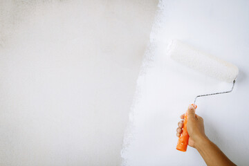 Roller Brush Painting, Worker painting on surface wall  Painting apartment, renovating with white...
