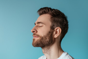 Obraz premium A close up of a man with beard and closed eyes looking to a side