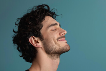 Fototapeta premium A close up of a man with beard and closed eyes looking to a side