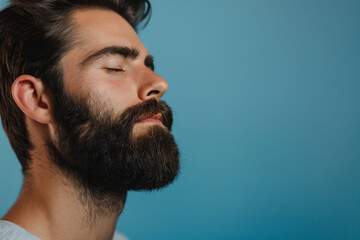 Fototapeta premium A close up of a man with beard and closed eyes looking to a side