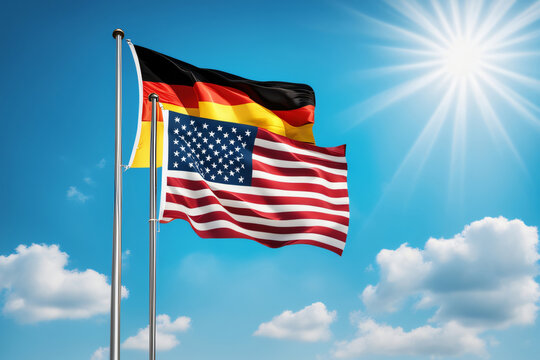USA und BRD Flagge vor blauem Himmel im Wind als Hintergrund
