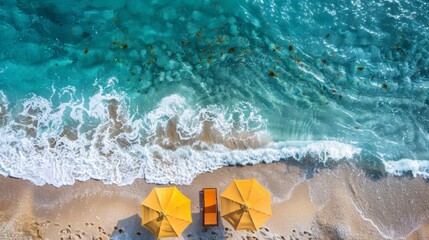 A top view of beach chairs, umbrella, and serene ocean waves, offering ample space for text