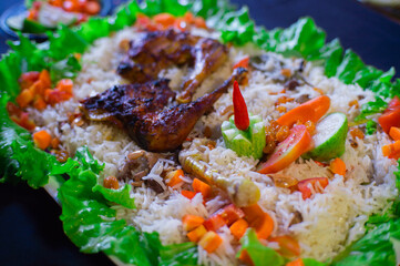 kabsa, rice, a typical Arabic dish, with grilled chicken and fresh vegetables