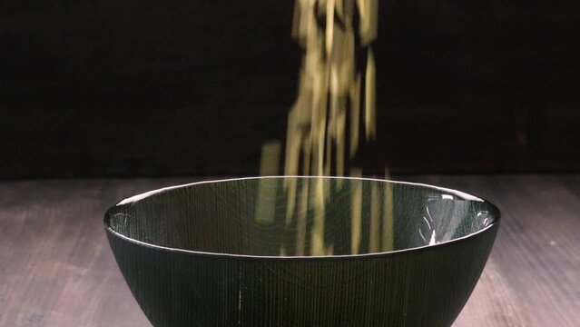 whole rice falling into a bowl, video