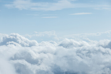 Fototapeta premium The sky is filled with fluffy white clouds, creating a serene
