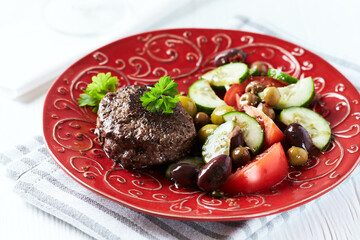 Fried hamburger steak with fresh salad. Wooden background. Close up.	