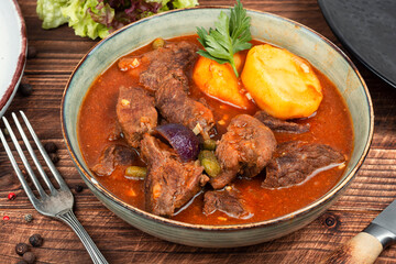 Roast venison with potatoes.