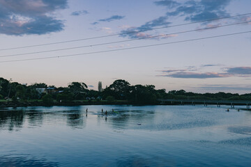 Children playing in the shallow water of Simpsons Creek, late afternoon at Brunswick Heads