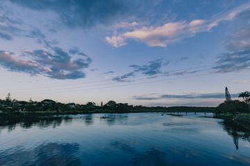 Children playing in the shallow water of Simpsons Creek, late afternoon at Brunswick Heads