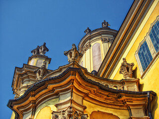 Cultural Monument: A historic building&rsquo;s facade with statues and gilded accents, set against a blue sky, reflecting cultural pride. St. George's Cathedral in the city of Lviv.