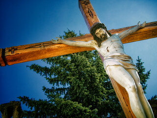 Crucifixion Scene: A crucifix with Jesus, depicting Christian iconography, bathed in sunlight,...