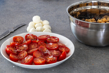 Sliced cherry tomatoes with sea salt and mozzarella balls.