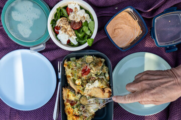 Stockholm, Sweden A picnic with plastic plates including quiche and a caprese salad.