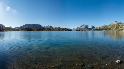 Fototapeta premium Serene Mountain Lake Landscape with Clear Blue Sky for Text Overlay