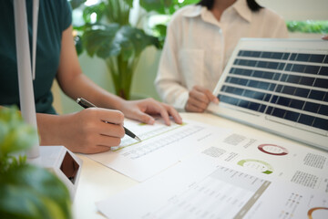 Solar panels green energy Business people working in green eco friendly office business...