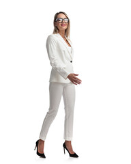 young businesswoman in white suit stepping to side