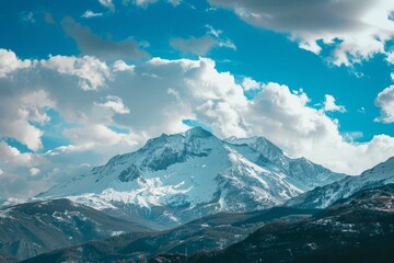 Obraz premium Majestic Snow-Covered Mountain Range with Clear Sky for Text Placement