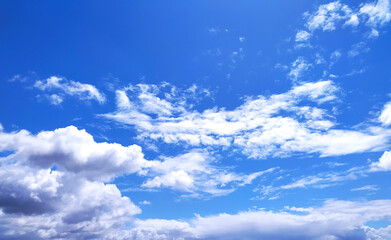 Clear blue sky texture and white fluffy cloud nature background. The sun shines bright in the daytime in summer