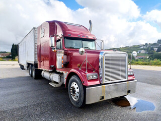 Red Semi Truck Parked on Side of Road