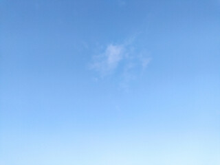 Clear blue sky texture and white fluffy cloud nature background. The sun shines bright in the daytime in summer