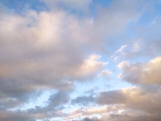 Sun Setting Over Clouds in Sky