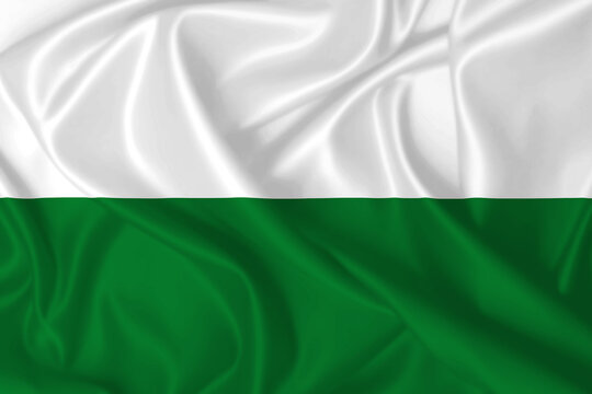 Flag of Styria and Saxony waving in the wind on silk texture