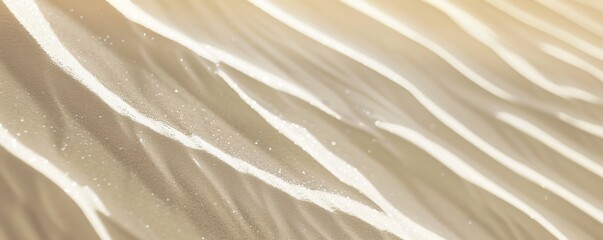 Obraz premium Desert sand. Close-up view of desert sand with subtle white hues color, showing delicate ripples and textures. The soft lighting accentuates intricate patterns, creating a serene captivating scene