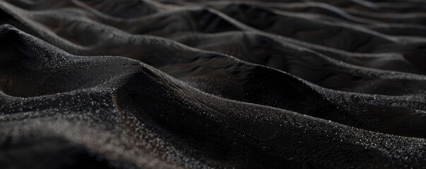 Desert sand. Close-up view of desert sand with subtle black hues color, showing delicate ripples and textures. The soft lighting accentuates intricate patterns, creating a serene captivating scene