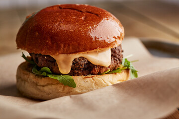 Cheeseburger with rocket in a brioche bun