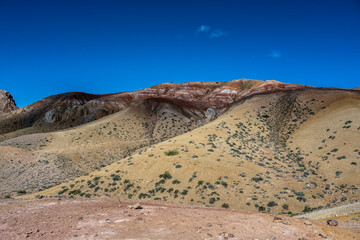 panoramic landscape with unusual red mountains with a Martian view filmed from a drone in Altai in May
