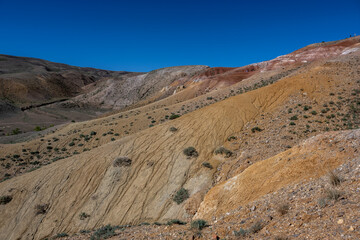 panoramic landscape with unusual red mountains with a Martian view filmed from a drone in Altai in May