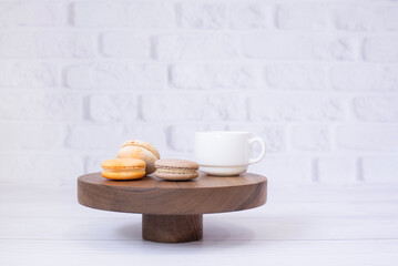 A cup of coffee tea and macaroons on a wooden tray. On the background. Breakfast