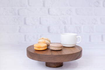 A cup of coffee tea and macaroons on a wooden tray. On the background. Breakfast