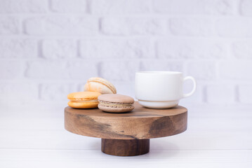 A cup of coffee tea and macaroons on a wooden tray. On the background. Breakfast