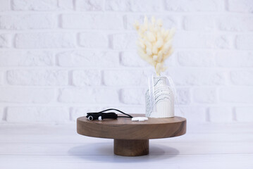 Vase with dry flowers. Jewelery Decoration on a wooden stand
