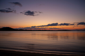 A tranquil beach bathed in a serene sunrise Nature composition.