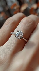 Obraz premium Close-up, female fingers with a beautiful diamond ring, an exclusive and luxurious piece of jewelry.