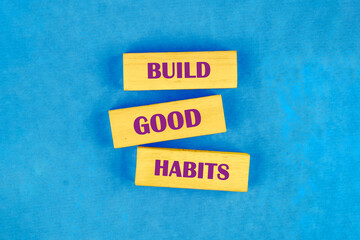 Business, psychology and build good habits concept, copy space. Words BUILD GOOD HABITS on blocks made of wood, top view Conceptual photo
