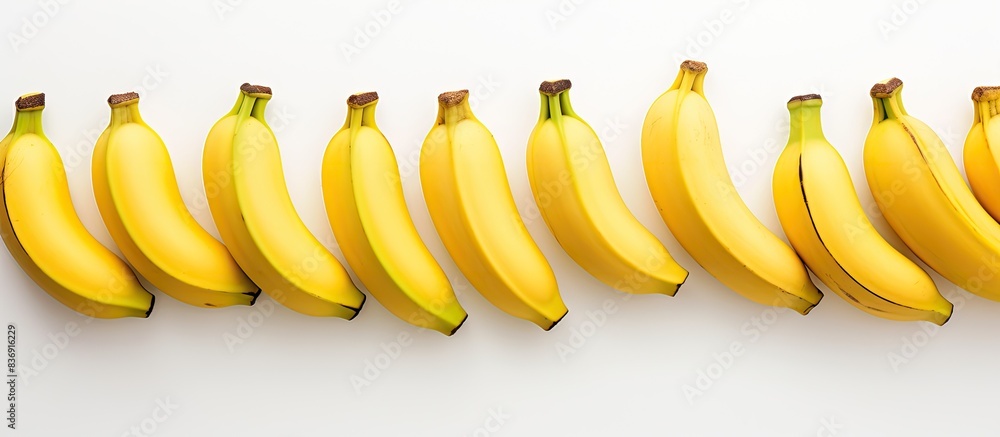 Poster Bananas arranged with copy space image on a white backdrop.