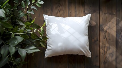 A white square pillow sitting on the floor next to greenery against a dark wood background. emphasizes the cushion's clean lines and modern look for interior decoration.