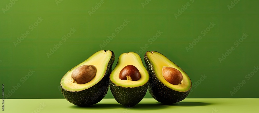Poster avocado halves with a copy space image.