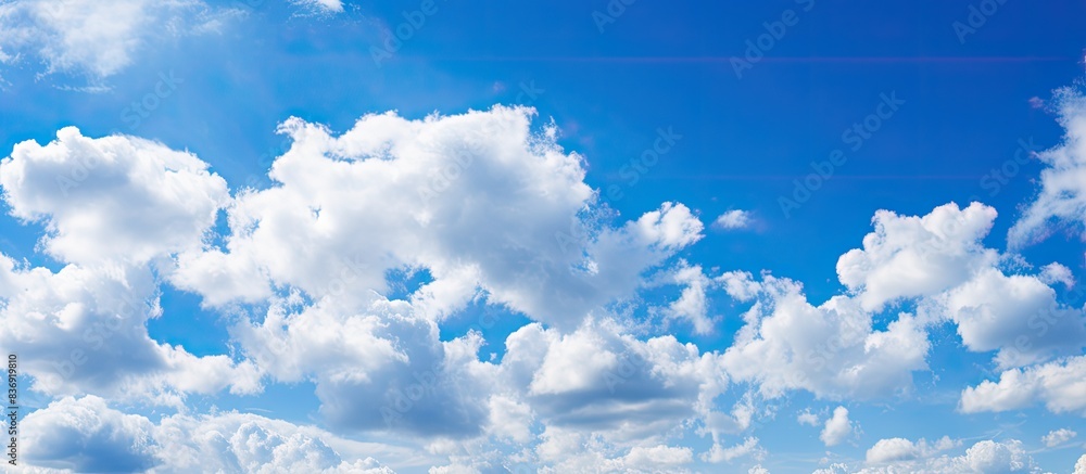 Poster blue skies filled with fluffy white clouds on a sunny day create a picturesque scene with a copy spa