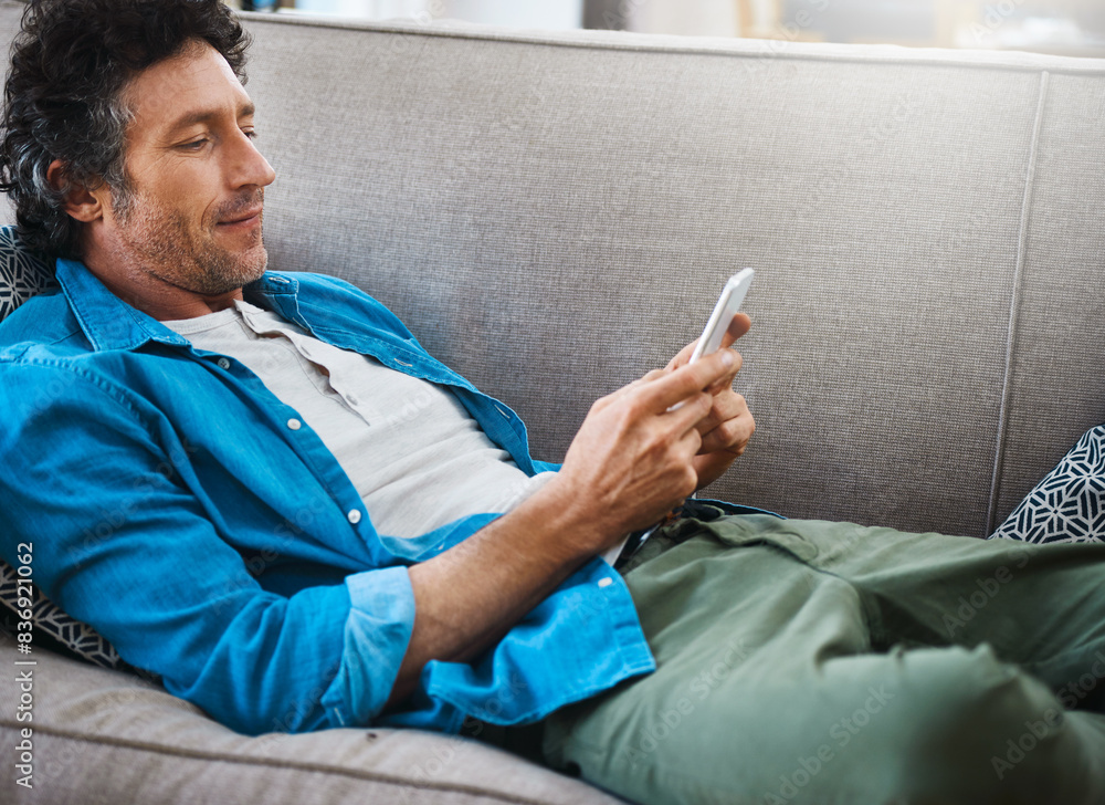 Poster Man, home and relax on sofa with smartphone for social media post, networking and communication. Living room, couch and browse internet for online chat, conversation and mobile app with texting