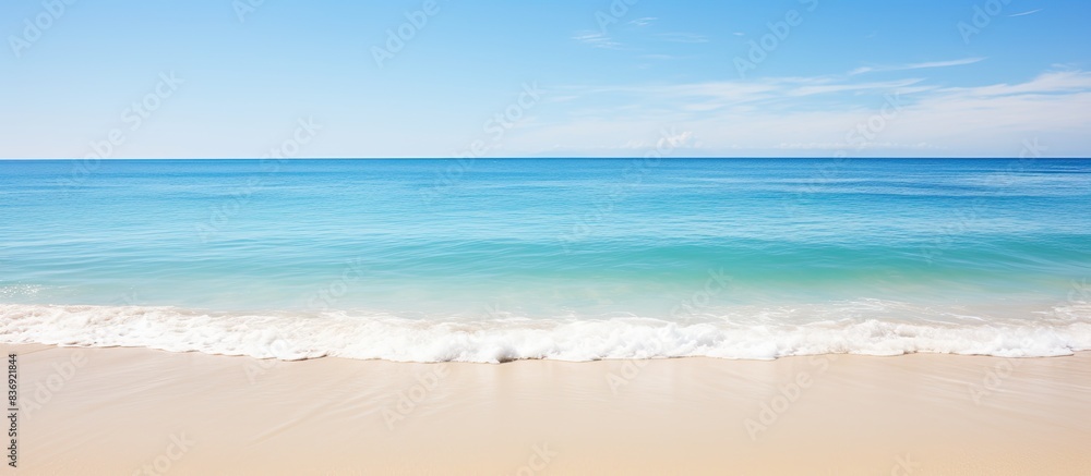 Poster Scenic view of a crystal clear beach with a blue sky, showcasing a tranquil setting perfect for a copy space image.