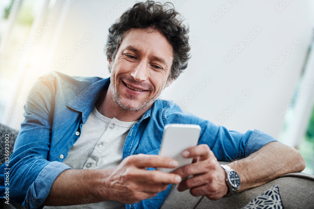 Poster man, home and smile on sofa with smartphone for social media post, networking and communication. liv
